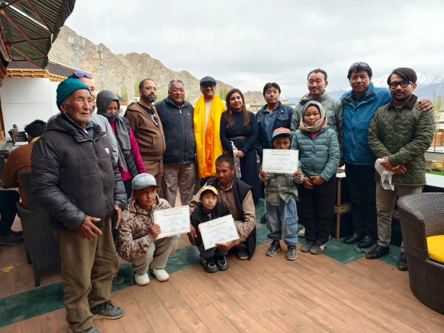 Children from taxi-driver families in Ladakh, supported by O J Agrawal Charitable Trust, with their families during the April 2026 visit by Dr. Ravi Agrawal and members of the Trust