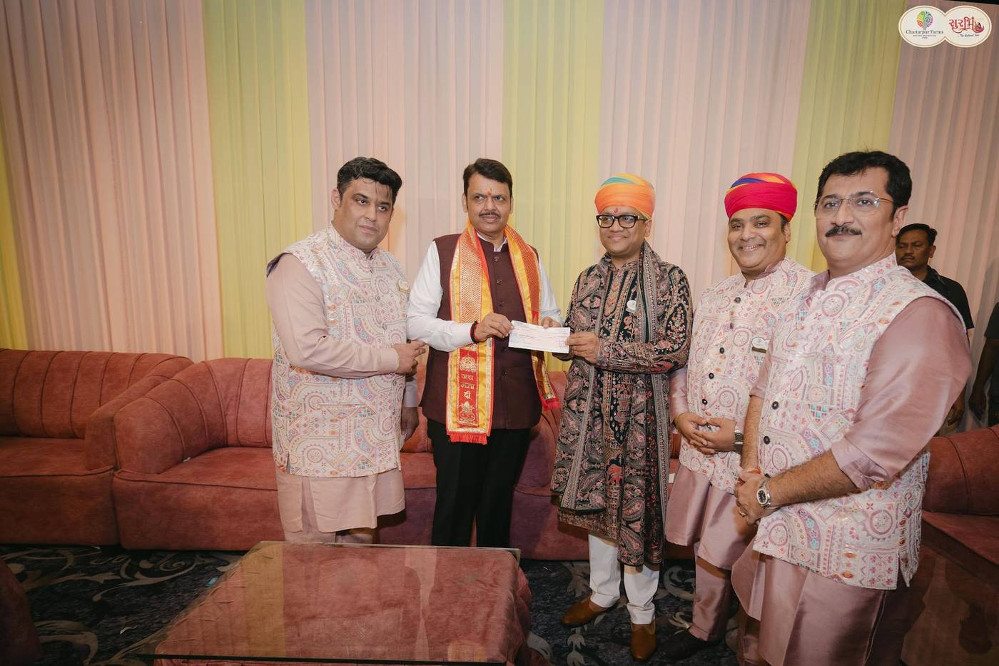 Maharashtra Chief Minister Shri Devendra Fadnavis receiving a contribution to the Chief Minister's Relief Fund at Surbhi, the Navratri hosted by Dr. Ravi Agrawal's family at Chattarpur Farms, with O J Agrawal Charitable Trust among the community associates