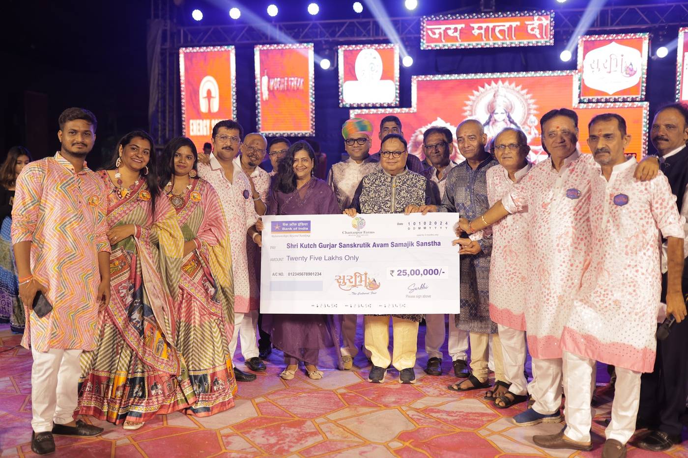 A contribution to Shri Kutch Gurjar Sanskrutik Avam Samajik Sanstha at Surbhi, the Navratri hosted by Dr. Ravi Agrawal's family at Chattarpur Farms, with O J Agrawal Charitable Trust taking part in the handover